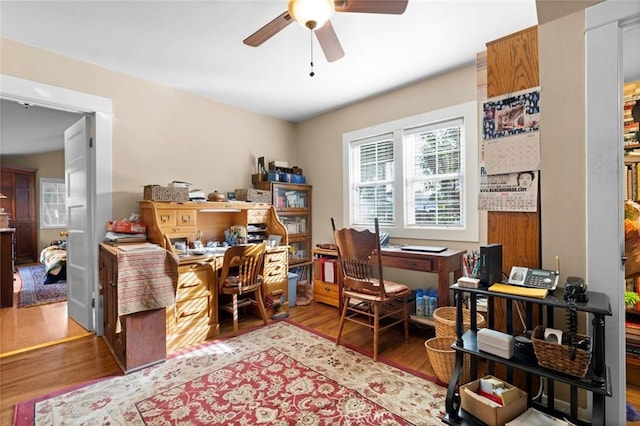 home office featuring hardwood / wood-style floors and ceiling fan