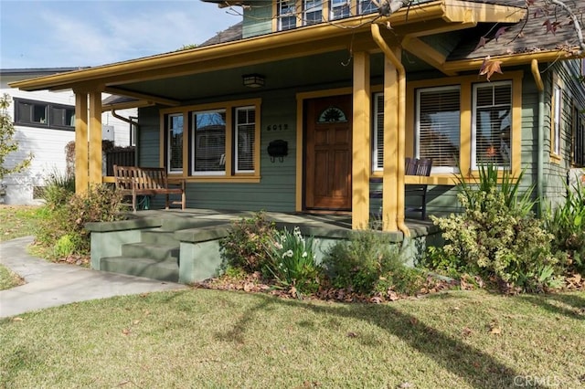 property entrance featuring a yard and a porch