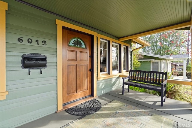 view of exterior entry with a porch