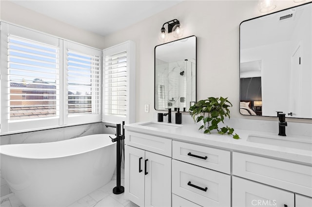 bathroom featuring vanity and independent shower and bath