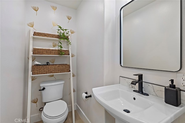 bathroom with sink, wood-type flooring, and toilet