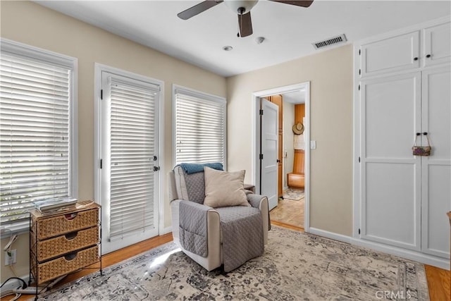 sitting room with light hardwood / wood-style floors and ceiling fan