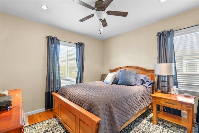 bedroom with light hardwood / wood-style flooring and ceiling fan