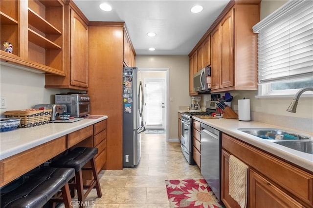 kitchen with light tile patterned flooring, appliances with stainless steel finishes, and sink