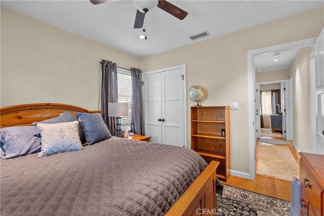 bedroom with ceiling fan, hardwood / wood-style floors, and a closet