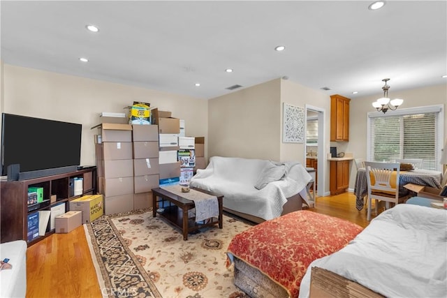 living room featuring a notable chandelier and light hardwood / wood-style floors