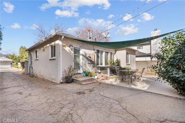 back of property with a patio