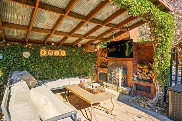 view of patio / terrace with an outdoor living space with a fireplace