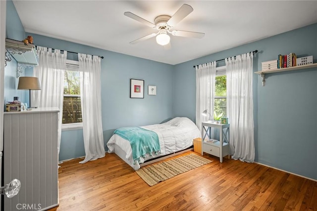 bedroom featuring ceiling fan and light hardwood / wood-style flooring