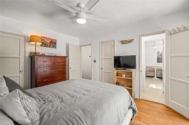 bedroom with light hardwood / wood-style floors and ceiling fan