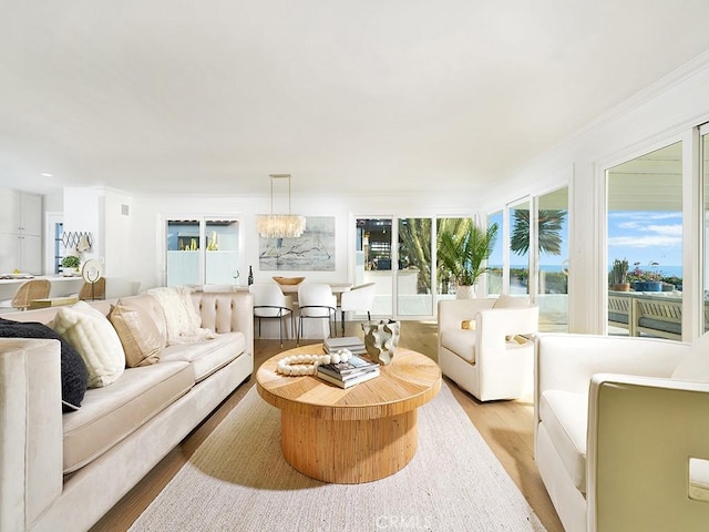 living room featuring a chandelier and light hardwood / wood-style floors