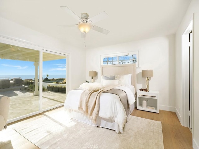 bedroom with light hardwood / wood-style flooring, access to outside, and ceiling fan