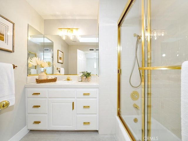 bathroom featuring enclosed tub / shower combo and vanity