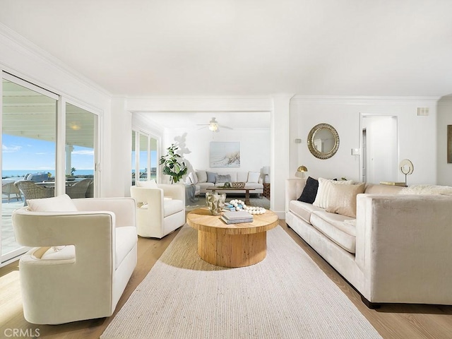 living room featuring crown molding, ceiling fan, and wood-type flooring