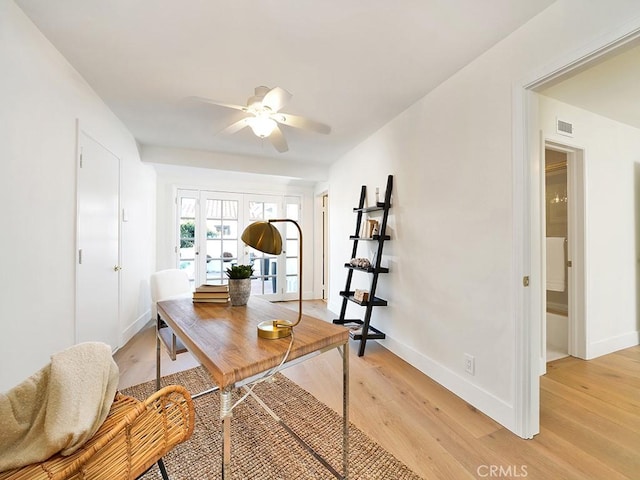 home office featuring ceiling fan and light hardwood / wood-style flooring