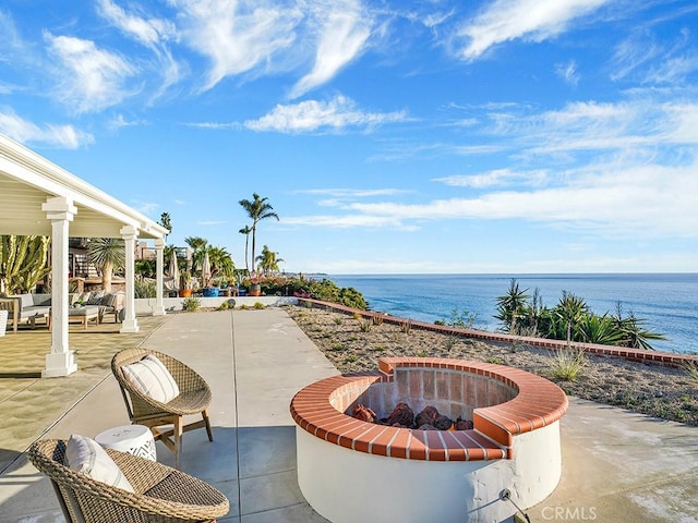 view of patio / terrace with a water view and an outdoor fire pit