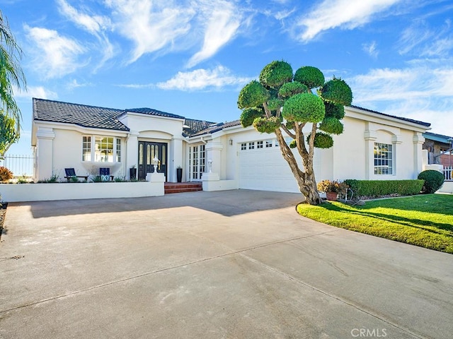 view of front of property with a garage and a front yard