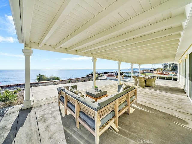 view of patio / terrace with a water view and an outdoor living space