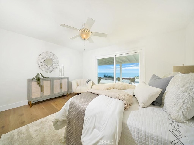 bedroom with ceiling fan, light wood-type flooring, and access to outside