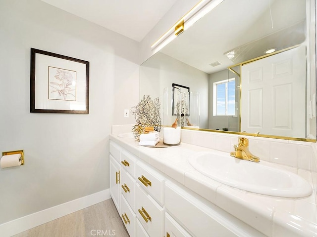 bathroom with hardwood / wood-style flooring and vanity