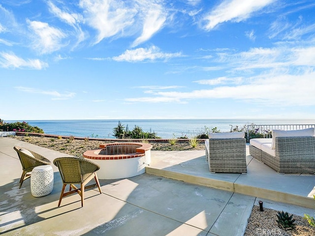 view of patio with a water view and outdoor lounge area