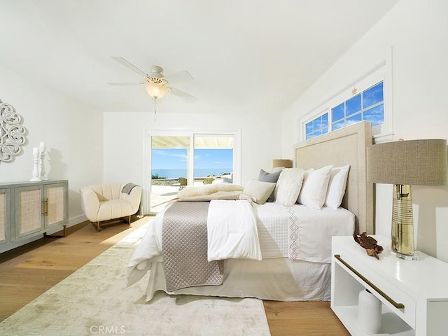 bedroom featuring access to outside, light hardwood / wood-style floors, and ceiling fan