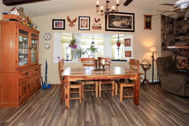 dining space featuring ceiling fan with notable chandelier, a textured ceiling, dark hardwood / wood-style flooring, and lofted ceiling with beams