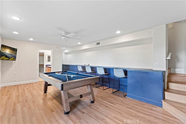 game room featuring light wood-type flooring, ceiling fan, bar, and pool table