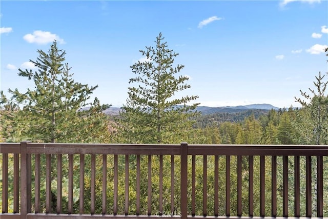 wooden deck with a mountain view