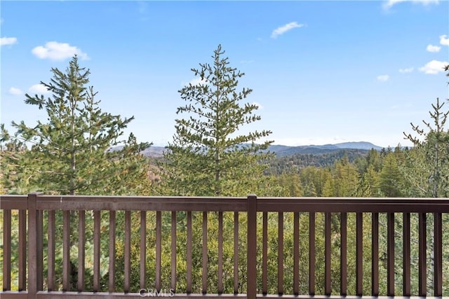 wooden deck with a mountain view