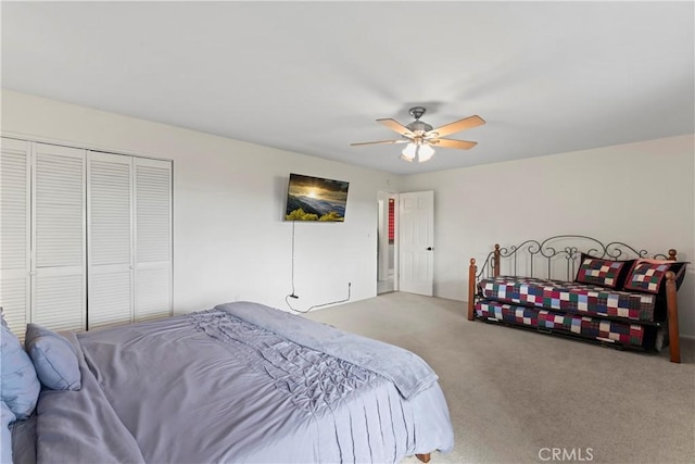 carpeted bedroom with ceiling fan and a closet