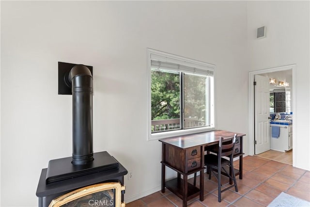 tiled dining room with a wood stove