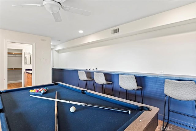 recreation room with hardwood / wood-style floors, pool table, bar area, and ceiling fan