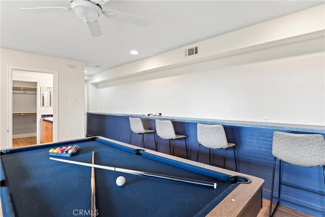 game room featuring hardwood / wood-style floors, billiards, and bar area