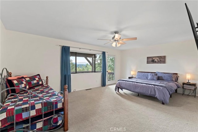 carpeted bedroom featuring access to outside and ceiling fan