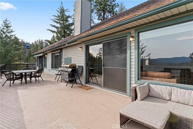 view of patio with a mountain view, outdoor lounge area, and a grill