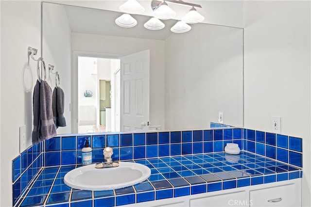 bathroom featuring vanity and backsplash