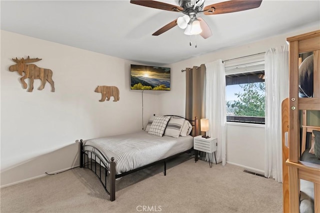 bedroom featuring light colored carpet and ceiling fan