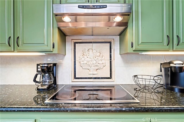 kitchen with black electric cooktop, tasteful backsplash, green cabinets, and ventilation hood