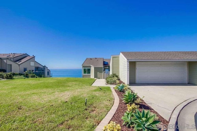 view of front of property featuring a water view, a garage, and a front yard