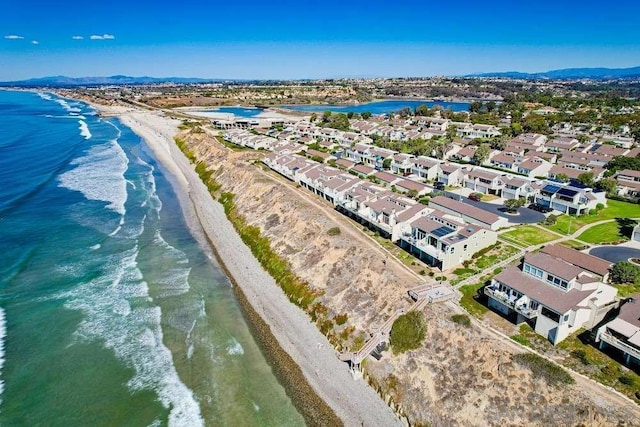 drone / aerial view featuring a water view and a beach view