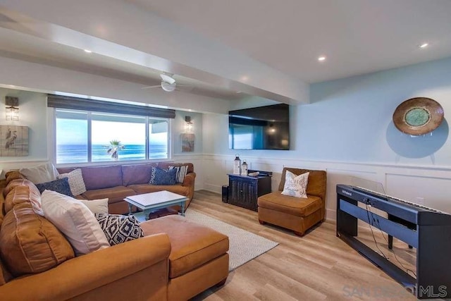 living room with ceiling fan and light hardwood / wood-style flooring