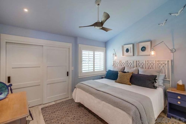 bedroom featuring vaulted ceiling, a closet, ceiling fan, and light hardwood / wood-style floors