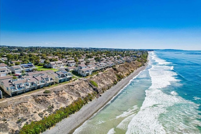 drone / aerial view featuring a water view and a beach view