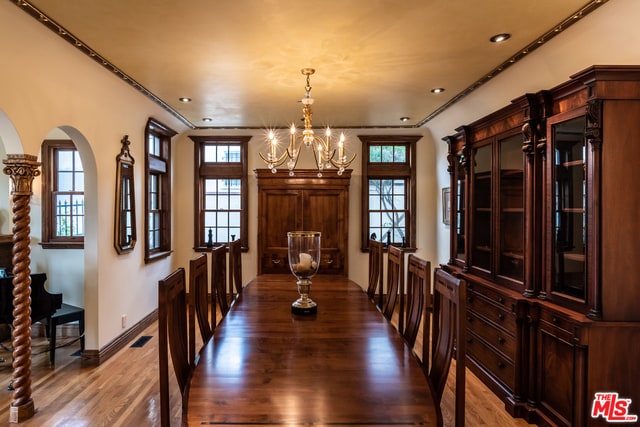 dining room featuring hardwood / wood-style flooring and a chandelier