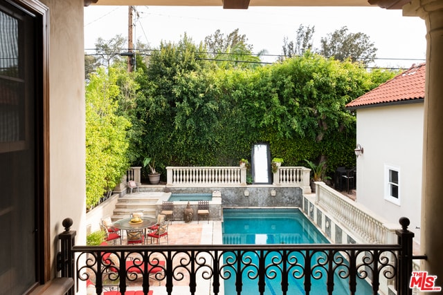 view of swimming pool with an in ground hot tub