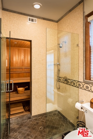 bathroom with tile walls, an enclosed shower, ornamental molding, and toilet