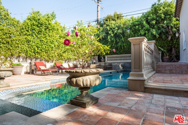 view of pool featuring a patio area