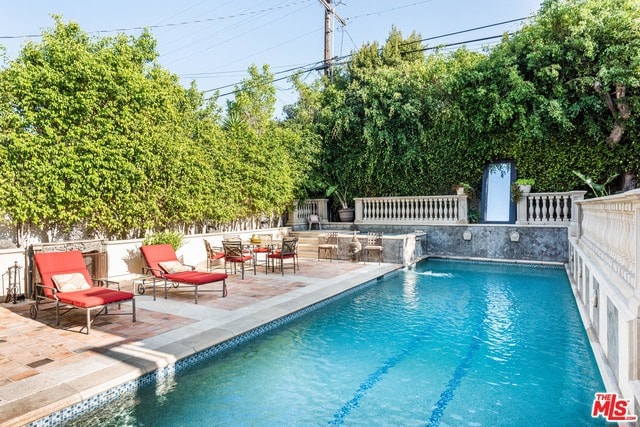 view of swimming pool with a patio