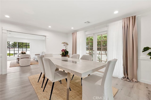 dining area featuring french doors and light hardwood / wood-style floors